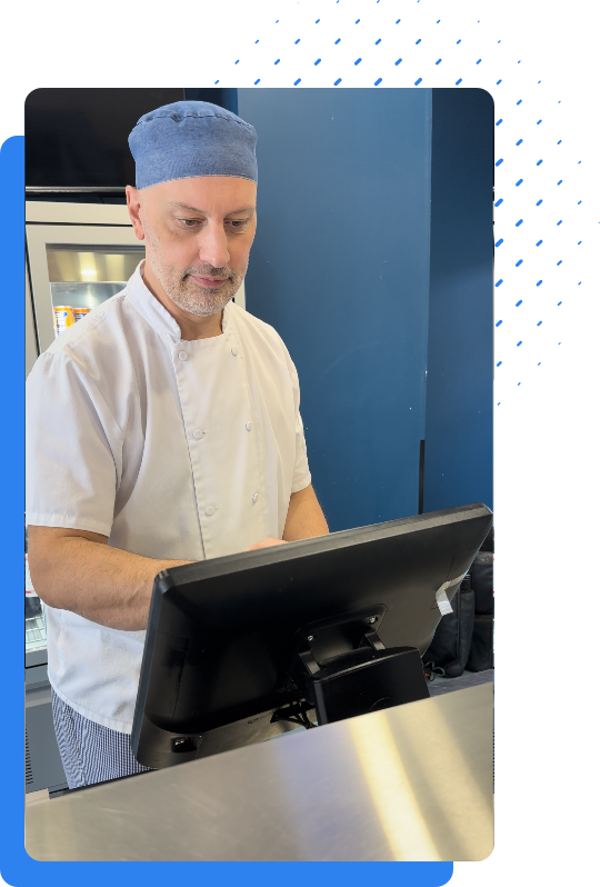Chef checking orders on Mealzo EPOS device in kitchen