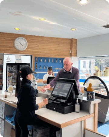 Staff at Giulio's Fish and Chips processing a payment using Mealzo’s EPOS system
